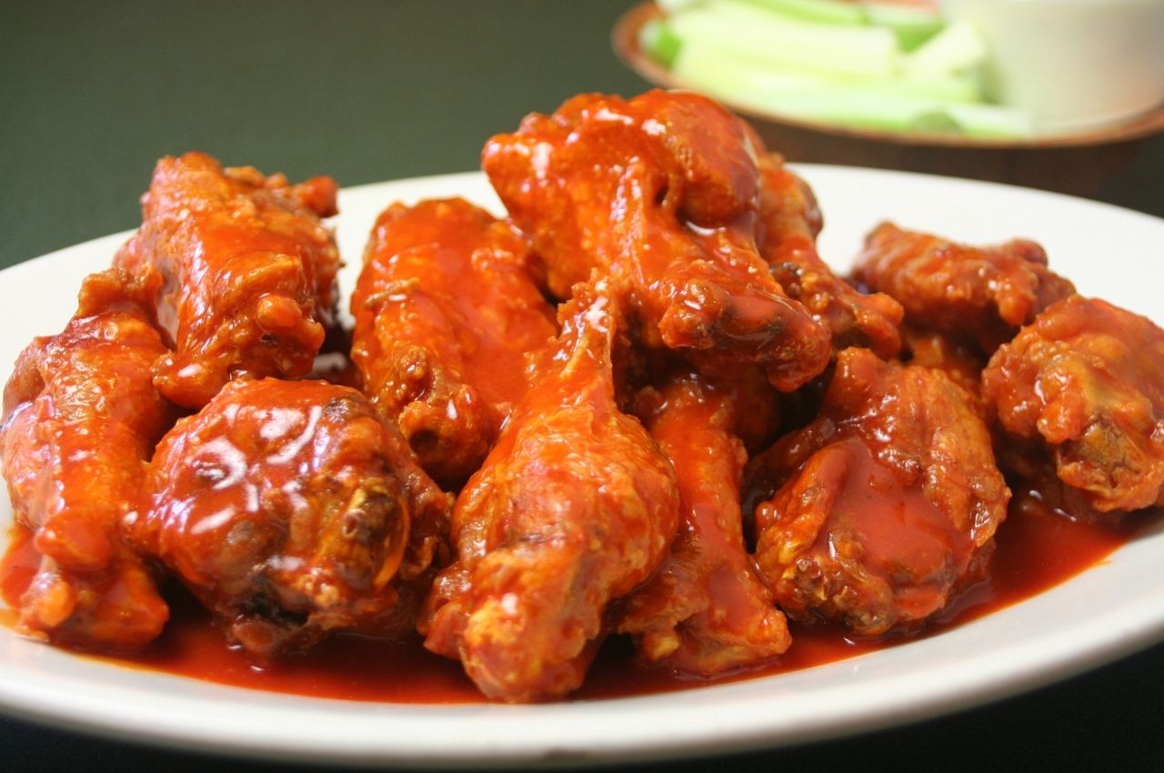 An image of stick buffalo wings on a white plate for our 10 high protein snack recipes