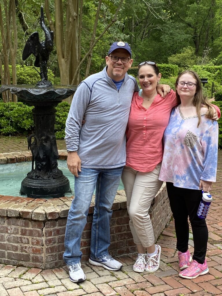 Renee's cute family in front of a fountain