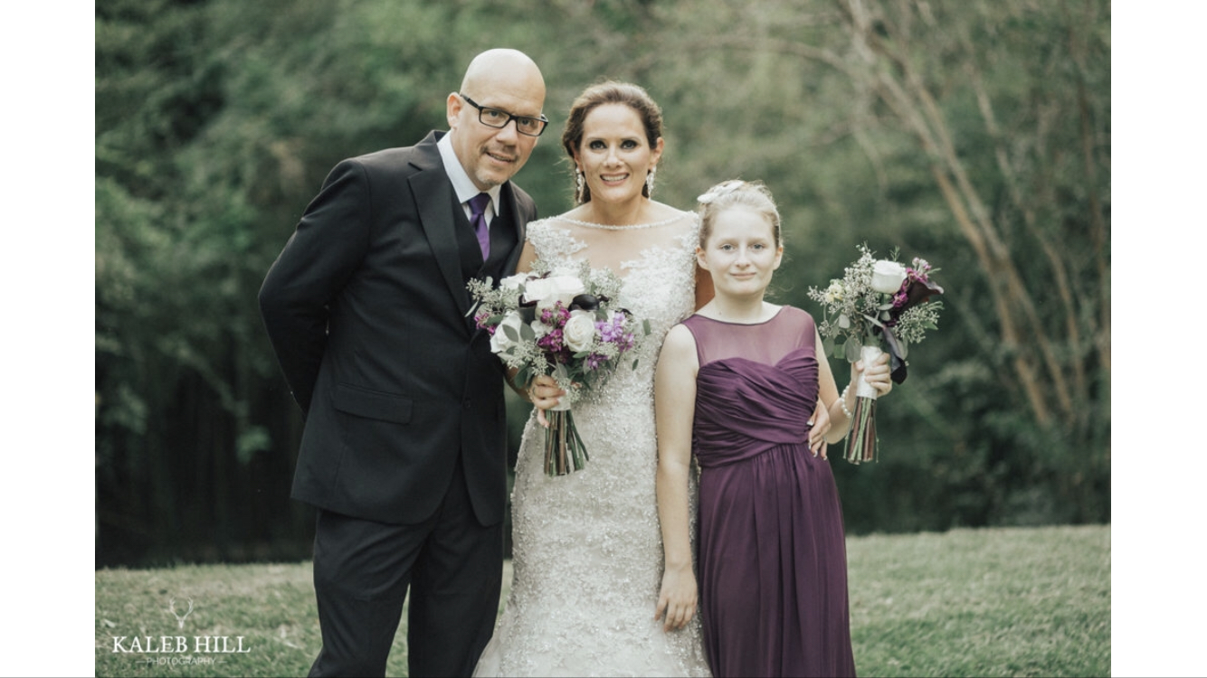 Renee with her husband and daughter at her wedding 